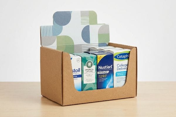 Kraft Display Tray Products Raw kraft paper corrugated display tray with a patterned header, showcasing Cetaphil, Nustiart, and Unsantial Lature products.