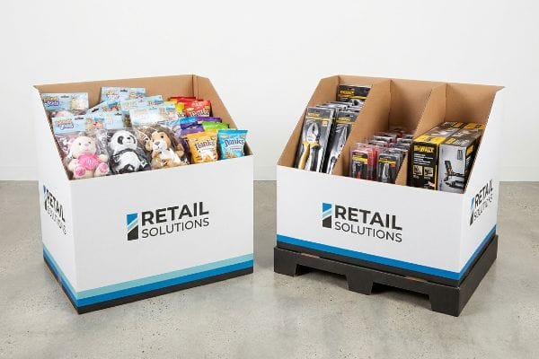 Corrugated Retail Solutions dump bins: one with plush toys and snacks, the other with Dewalt tools and hardware.