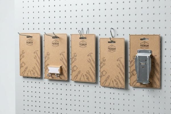 Premium Cardboard Hook Displays Brown Premium cardboard hang tags with tool illustrations, showcasing diverse peg, loop, and metal universal bracket hooks on a white pegboard.