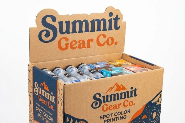 A retail dump bin display for Summit Gear Co. showcases water bottles and various packaged goods, featuring Spot Color Printing and outdoor-themed graphics.