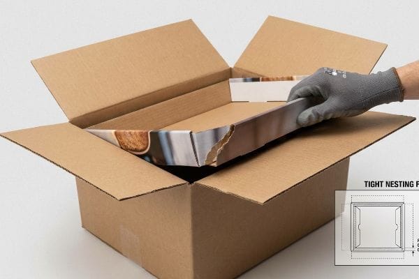Gloved hand inserts pre-packed retail display into corrugated master carton, revealing a torn retaining lip and a 'Tight Nesting Fail' diagram.