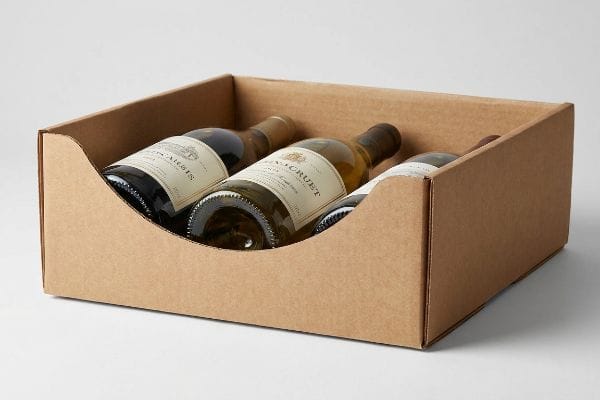 Brown corrugated cardboard tray with a custom die-cut swoop displaying three wine bottles for maximum label visibility.