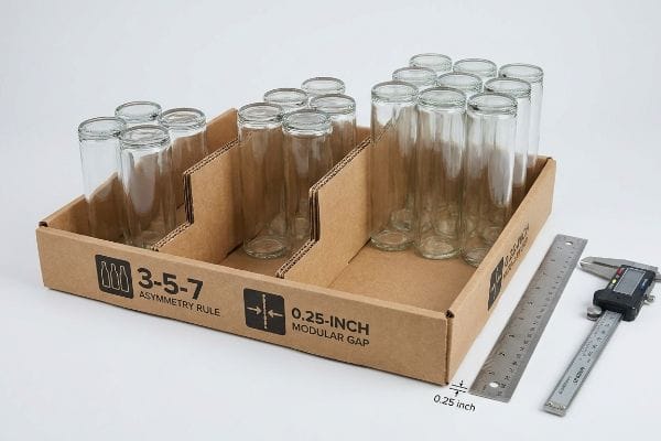 Modular Bottle Tray Spacing Corrugated tray with modular dividers holding glass bottles, featuring the 3-5-7 Asymmetry Rule and 0.25-Inch Modular Gap.