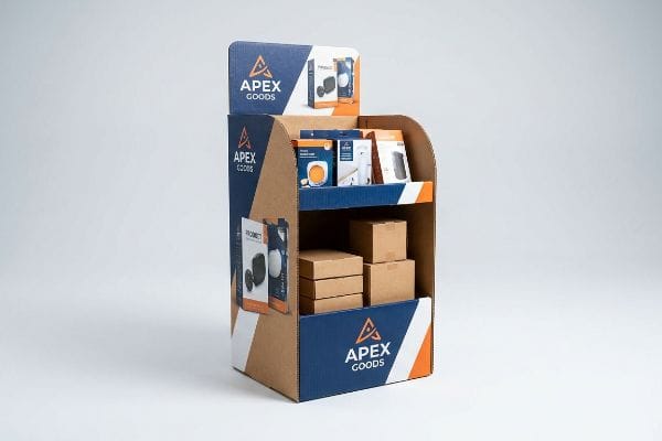Apex Goods Retail Display A corrugated retail display for Apex Goods, showcasing Promet product boxes and brown shipping boxes on shelves, against a light background.