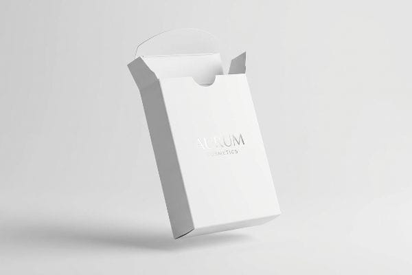An open white straight tuck box for Aurum Cosmetics, featuring a silver foil logo, floating against a light background.