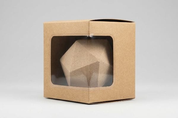Bath Bomb Window Box Brown kraft paper die-cut window box displaying a geometric custom-shaped product, possibly a bath bomb mold, through an elastic window patch.