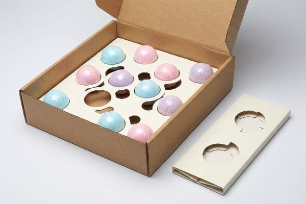 Bath Bomb Gift Set Brown corrugated box with die-cut modular dividers holding pastel bath bombs, ideal for gift set packaging.
