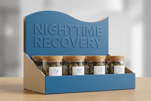 Nighttime Recovery CBD Display Blue kraft display box with 'Nighttime Recovery' text, showcasing glass jars of CBD hemp flower with cork lids.