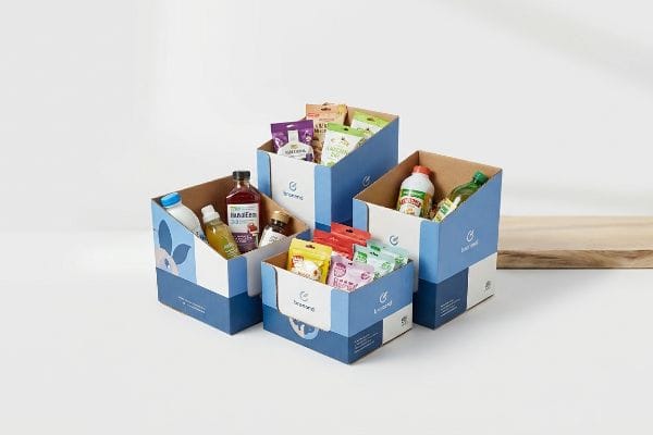 Retail Display Boxes Showcasing brand recognition, four blue and white corrugated display boxes, branded 'Brand', filled with diverse food and beverage products.