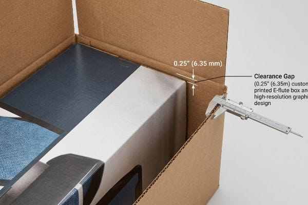 Engineered Clearance Gap Measurement Brown corrugated master carton showing a 0.25" (6.35 mm) clearance gap measured by a caliper, preventing nested friction for a custom printed E-flute box.