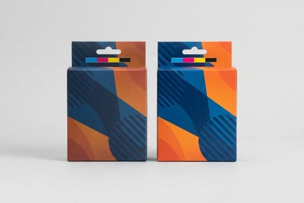 CMYK Packaging Boxes Two vibrant packaging boxes with geometric blue and orange designs, featuring a CMYK color bar on the hang tab.