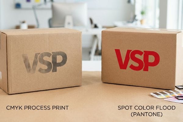 CMYK vs Spot Color Corrugated cardboard boxes showcase VSP logo printing: grainy CMYK Process Print vs. vibrant Spot Color Flood (Pantone).