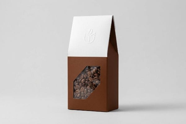 Coffee Box Packaging Design Brown coffee box with a white top, die-cut window showcasing roasted beans, and an embossed leaf logo.