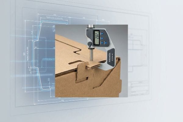 Corrugated Flute Thickness Measurement A Mitutoyo digital micrometer precisely measures the 2.82 mm flute thickness of corrugated cardboard, highlighting packaging design accuracy.