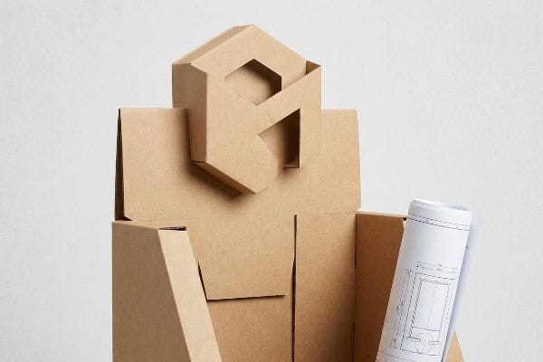 Cardboard 3D Structural Packaging Natural brown corrugated cardboard 3D die-cut packaging structure with a rolled blueprint, showcasing structural geometry.