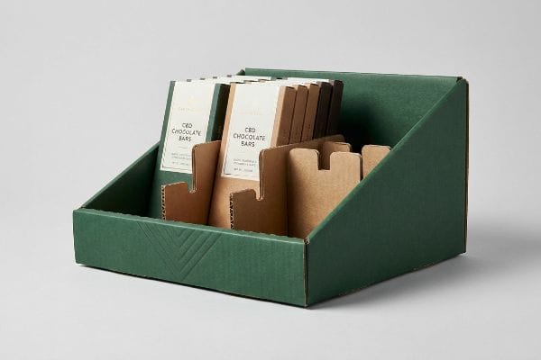 CBD Chocolate Display Tray Dark green corrugated retail merchandiser with inward debossing, showcasing CBD Chocolate Bars in brown packaging held by precise dividers.