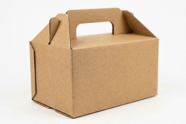 Brown Gable Box Packaging A plain brown corrugated gable box with a built-in top handle, showcasing its sturdy cardboard construction.