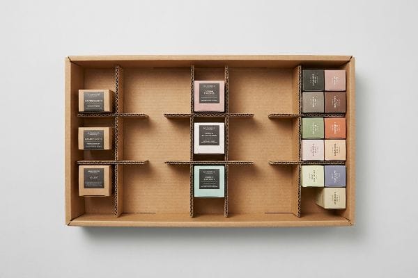 Modular Product Display Modular corrugated display tray with A. L'Amour product boxes in asymmetrical clusters, demonstrating retail merchandising.