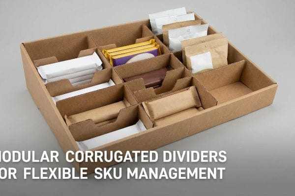Brown corrugated tray with Modular Corrugated Dividers for Flexible Sku Management, organizing diverse wrapped candy and snack bars.