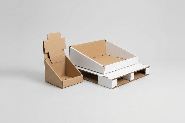 Natural brown kraft countertop display and a white shelf-ready tray on a mini pallet merchandiser, showcasing retail POP packaging.