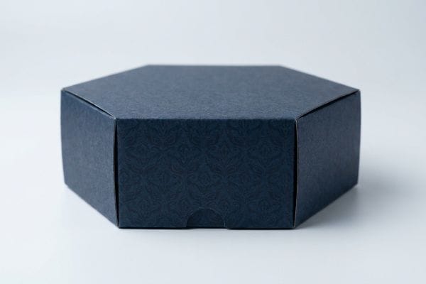 Dark Blue Hexagon Box Dark blue hexagonal box with subtle pattern, showcasing precise crease lines for geometric packaging.