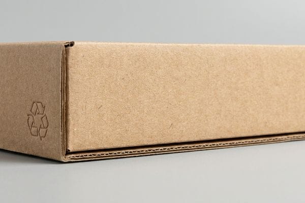 Eco-Friendly Corrugated Packaging Corrugated paperboard eco-friendly packaging with a debossed recycling symbol, highlighting sustainable design and material texture.
