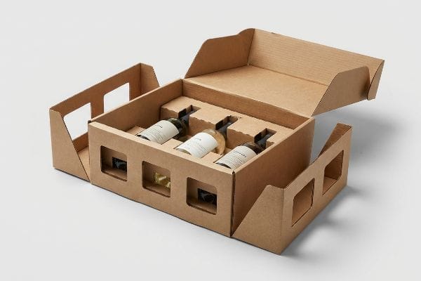 An open die-cut corrugated cardboard box with integrated bottle inserts securely holding three wine bottles, showcasing custom retail packaging.