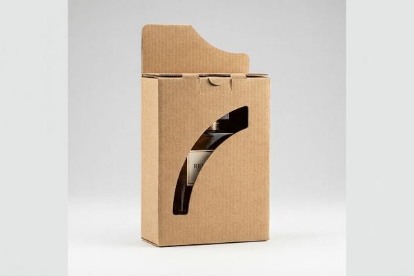A brown corrugated die-cut packaging box features a curved window, revealing a bottle with a 'Re' label, designed for product display.