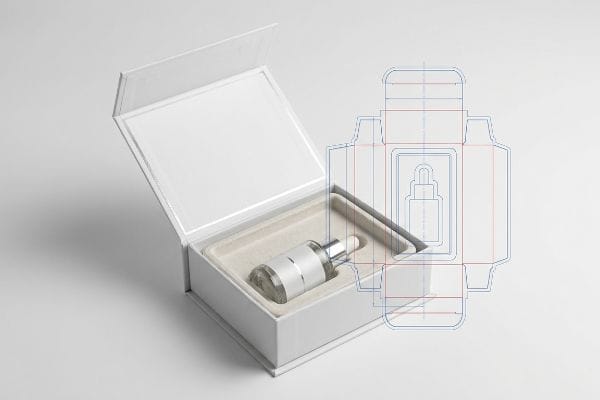 An open white rigid box displays a dropper bottle, alongside a die-cut blueprint for cosmetic packaging.