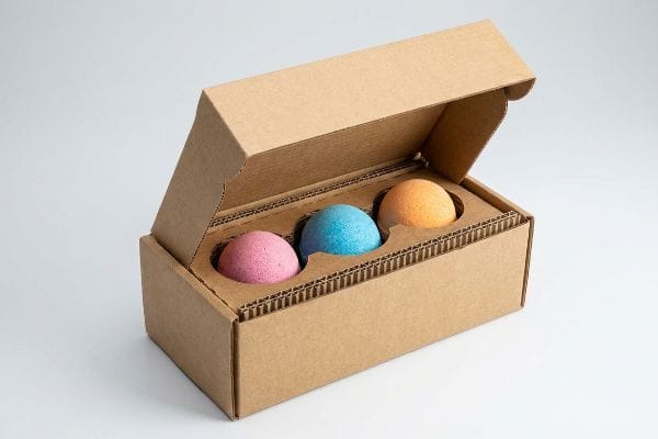 Bath Bomb Packaging E-Flute Brown E-flute corrugated box with three colorful bath bombs (pink, blue, orange) in a protective suspension insert, ideal for fragile spheres.