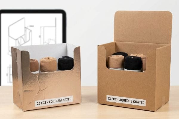 Rose gold foil laminated 26 ECT display box and natural kraft 32 ECT aqueous coated box, both holding rolled hosiery.