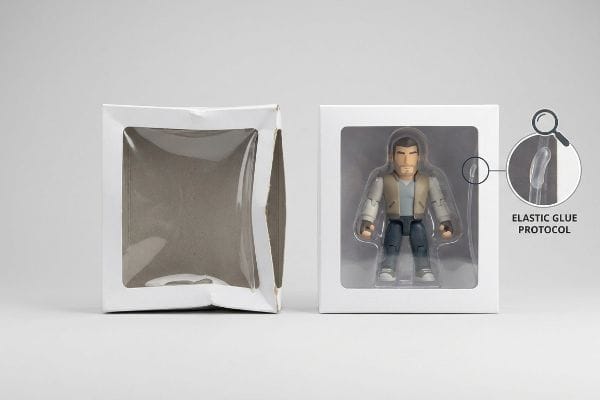 Two white die-cut window boxes, one empty and one with an action figure, highlighting the Elastic Glue Protocol for flexible window patches.