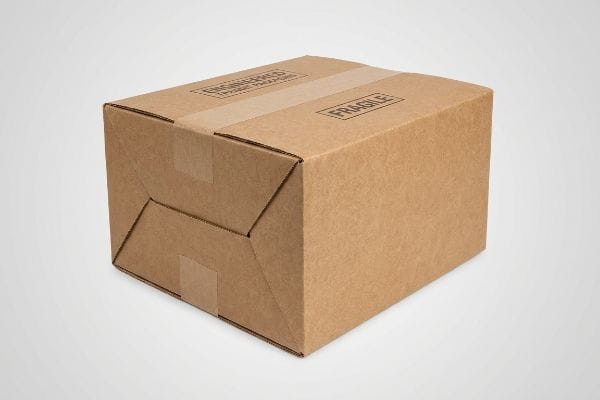 Brown corrugated shipping box sealed with tape, featuring 'Engineered' and 'Fragile' labels, highlighting robust transit packaging.