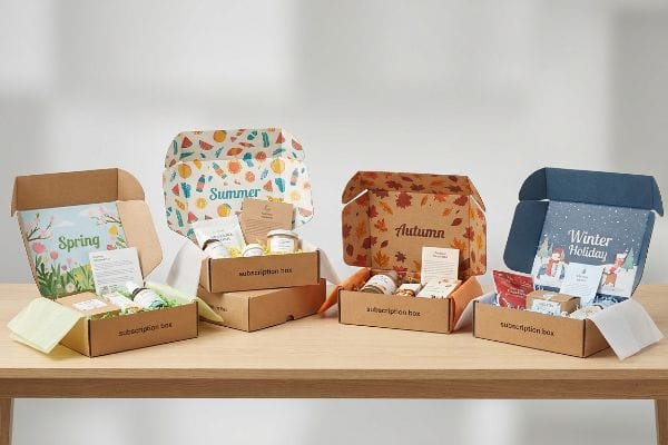 Kraft corrugated subscription boxes themed for Spring, Summer, Autumn, and Winter Holiday, showcasing seasonal custom graphics and products.