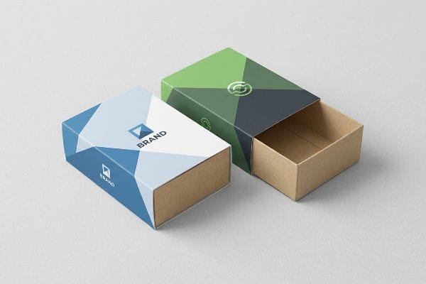 Geometric Sleeve Boxes Two sleeve custom boxes, one closed with blue and white geometric patterns and a 'Brand' logo, the other open with green and grey designs revealing a kraft brown tray.