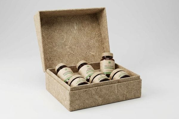 Hemp Product Display Box An open, textured hemp display box holds six dark bottles with 'Hayomma', 'Hemp Product', and 'Heilourac' labels.