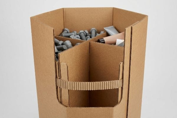 Hexagonal Dump Bin Contents Corrugated hexagonal dump bin with internal belly band and H-divider, filled with gray bolts and cosmetic tubes.