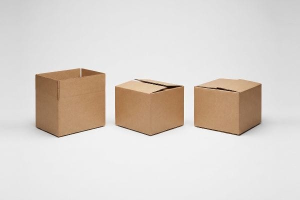 Corrugated Box Configurations Brown corrugated boxes: one open Half Slotted Container (HSC), one partially closed, and one fully sealed Regular Slotted Container (RSC), on a white background.