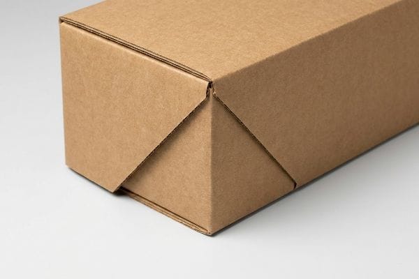 Brown corrugated cardboard box corner with precise, interlocking folds, showcasing durable packaging.
