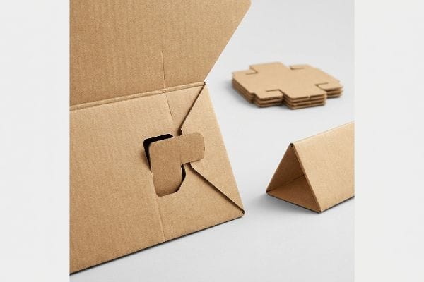 Cardboard Interlocking Mechanism Brown corrugated cardboard box with an interlocking friction tab, flat die-cut pieces, and a triangular fold.