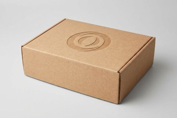 Debossed Subscription Box Brown corrugated cardboard subscription box with a subtle inward debossed logo on the lid, highlighting premium tactile packaging.