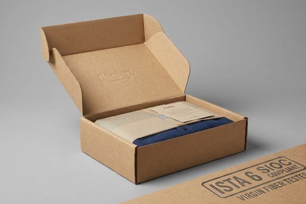 Professional Clothing Box Brown corrugated box with a blue shirt and "Ista 6 Sioc Compliant Virgin Fiber Tested" stamp.