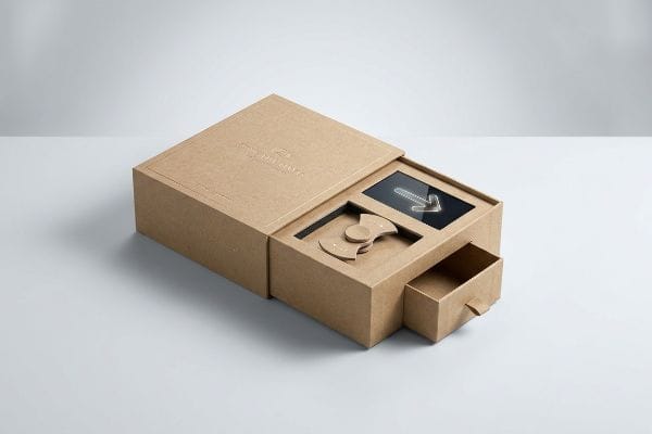 Interactive kraft packaging box featuring a kinetic spinner, black insert with a white arrow, and a small pull-out drawer.