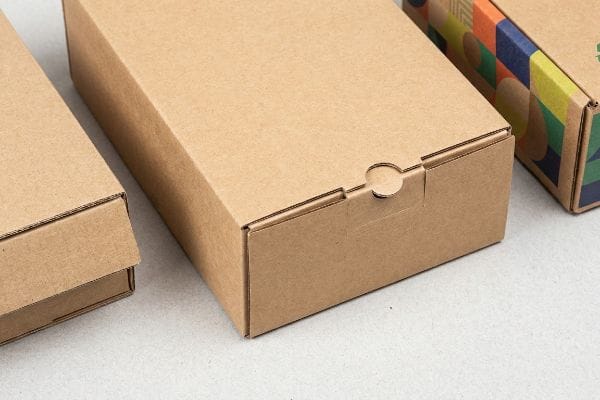 Corrugated Friction-Lock Box A close-up view shows a natural kraft corrugated box with a friction-lock closure, alongside a colorful digitally printed box.