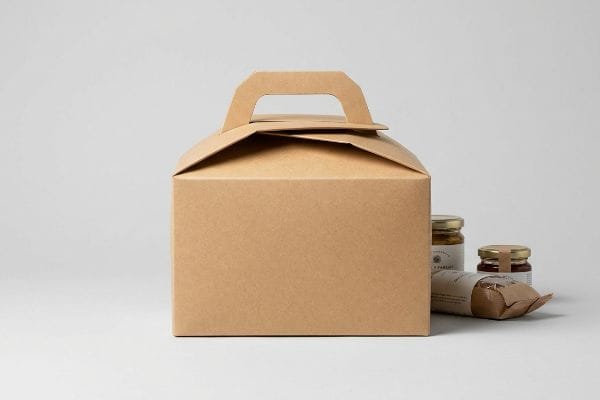 Kraft Gable Box Kit Kraft paper gable box with an origami-style handle, alongside two gourmet food jars and a wrapped item.