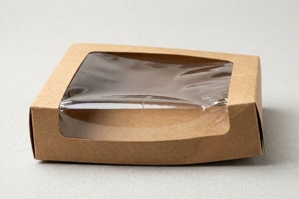Kraft Window Box Packaging Brown kraft paper folding carton with a clear PET plastic viewing window, showcasing the die-cut void.