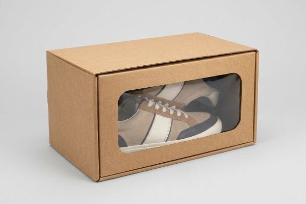Windowed Kraft Shoe Box Brown kraft cardboard shoe box with a shop-through window displaying beige, white, and navy sneakers, highlighting visual accessibility.