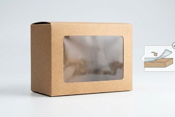 Brown Kraft paperboard window packaging box with transparent film, illustrating surface tension and adhesive flexibility.