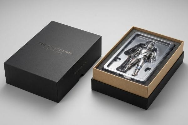 Mandalorian Collector's Edition Box An open Collector's Edition box reveals a silver Mandalorian action figure in a clear tray with foam, beside its black lid marked 'Precision Scale'.