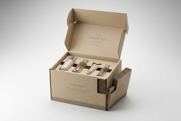 An open brown corrugated PopDisplay box securely holds four cosmetic product bottles, featuring 'Cosmetics' branding for eco-friendly packaging.